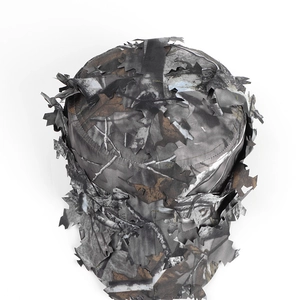Detailed macro view of 3D bionic camouflage leaves on a tactical woodland hunting cap