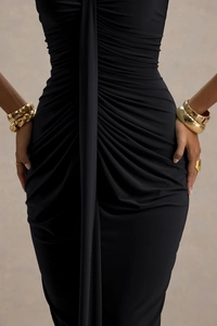 Detail of elegant ruched fabric and draped sash on the waist of a black bodycon dress