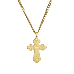 Detail of golden Orthodox cross pendant with IC XC religious engravings on link chain
