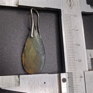 Teardrop gemstone pendant measuring 4.5cm length with calipers on black background