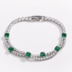 Detail view of double-layer tennis bracelet with square green gemstones and clear zircon