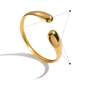 Macro shot showing dimensions and features of a minimalist gold teardrop cuff bangle