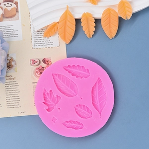 Pink silicone leaf mold for chocolate and fondant cake decoration on blue background