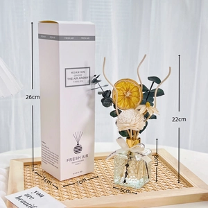 Detail view of reed diffuser packaging dimensions with dried flowers and glass bottle