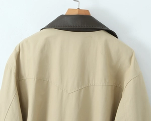 Detail of khaki jacket with dark brown leather collar stitching and V-shaped back tailoring