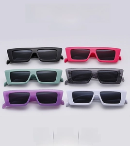 Flat lay of retro square sunglasses in six colors including black, pink, and mint green