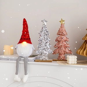 Luminous Santa gnome with sequined hat and plush legs next to sparkly Christmas trees
