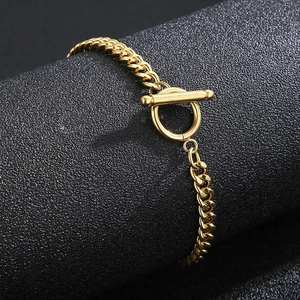 Detail view of gold stainless steel chain bracelet featuring a polished OT toggle clasp
