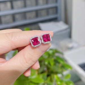 Elegant silver stud earrings featuring square red ruby stone with white diamond halo