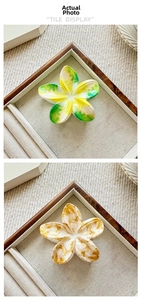 Detail of floral claw clips in gradient yellow-green and amber marble patterns