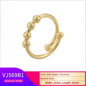 Detail of adjustable brass ring with five sliding gold beads and a twist design