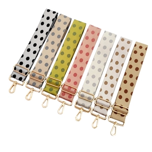 Adjustable wide shoulder straps with polka dot patterns and gold metal swivel hooks