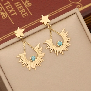 Bohemian gold star and sunburst turquoise earrings on beige leather jewelry case