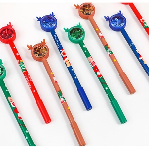 Close-up of Christmas pens with reindeer horns and glitter liquid sand balls