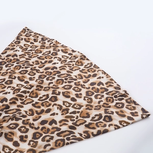 Close-up of leopard print fabric detail with ruffled edges and fine stitching craftsmanship