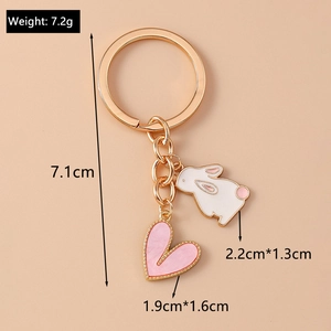Detailed view of golden heart and bunny keychain with precise measurement and size guide