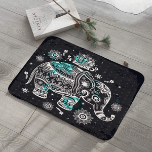 Black rectangular flannel floor mat featuring a turquoise mandala elephant on wood floor