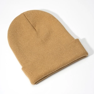 Detailed close-up of khaki acrylic knit beanie with classic ribbed cuff texture