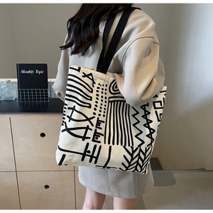 Artistic canvas tote bag with black abstract geometric patterns and large capacity