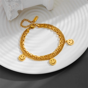 Three-layer gold stainless steel bracelet with snake, box, and bead chains with smile charms