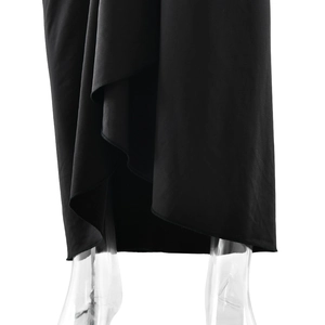 Detail shot of black bodycon dress hem featuring split design and ruched mesh texture