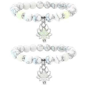 Close-up of double-layer beaded bracelets with silver lotus charm and luminous stones