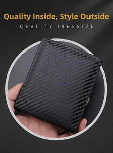 Close-up of the black carbon fiber texture and premium woven detail on the men's wallet