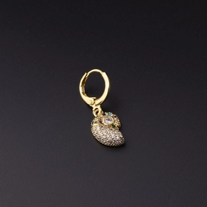 Macro detail of gold nautilus earring with white and multicolor pavé zircon crystals