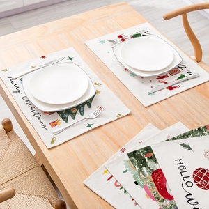 Christmas polyester placemat with festive tree and reindeer prints on a wooden table