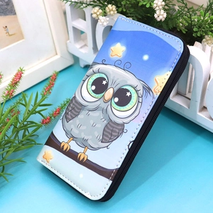 Detail view of a long blue zipper wallet featuring cute cartoon owl and star patterns