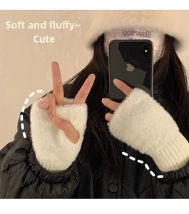Close-up of white plush fingerless gloves featuring soft faux fur and ribbed knit wrist cuffs