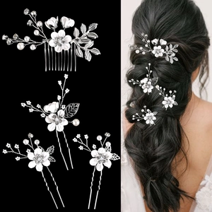 Detail of silver floral bridal hair accessories set with pearls and rhinestones