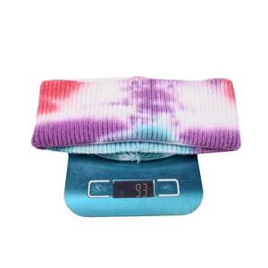 Detailed view of tie-dye knit beanie weighing 93g on a scale for product weight specification