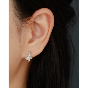 Close-up of S925 silver butterfly ear cuff with sparkling diamonds on female ear