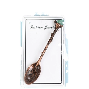 Retro bronze coffee spoon with carved floral patterns and a green crystal stone top