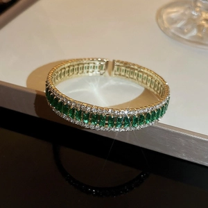 Sparkling gold bracelet with green rectangular gemstone and zircon accents for women