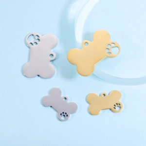 Polished stainless steel bone-shaped pet ID tags with hollow paw print in gold and silver