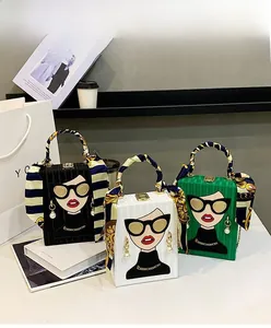 Detail of evening box bags with stripe texture, cartoon figure, and silk scarf handles