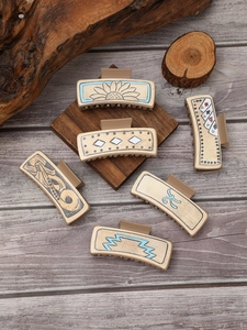 Detailed collection of vintage western style leather texture hair claw clips on wood