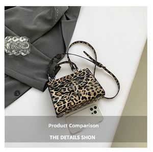 Detailed view of mini leopard print handbag showing adjustable strap and metal buckle