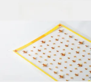Detailed view of 5D textured bee and flower nail stickers with embroidery effect