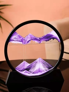 Close-up of circular hourglass sand art with purple and white peaks on a black stand