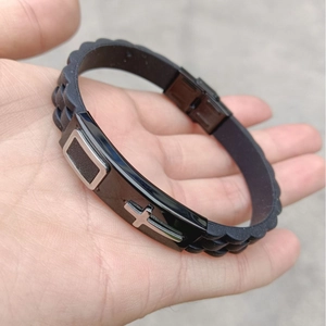 Silicone cross bracelet with wave texture and stainless steel buckle shown on wrist