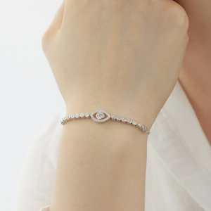 Close-up of S925 sterling silver evil eye bracelet with sparkling crystals on model wrist