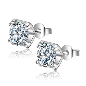 Macro shot of silver stud earrings featuring six-prong set round brilliant cut diamonds