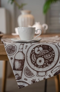 Detail view of woven fabric table runner featuring vintage hand-painted food illustrations