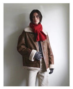 Brown aviator jacket with soft beige wool shearling lining and red knit winter scarf
