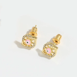 Macro view of gold Evil Eye and Hamsa Hand stud earrings with pink enamel and zircons