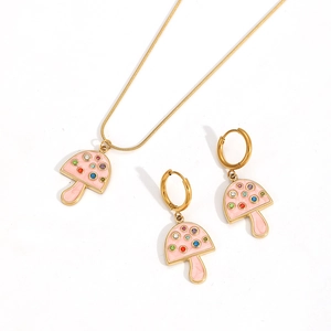 Detail of gold mushroom necklace and earrings set with pink enamel and colorful rhinestones