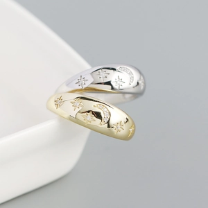 Macro shot of gold and silver S925 rings with celestial star and moon patterns